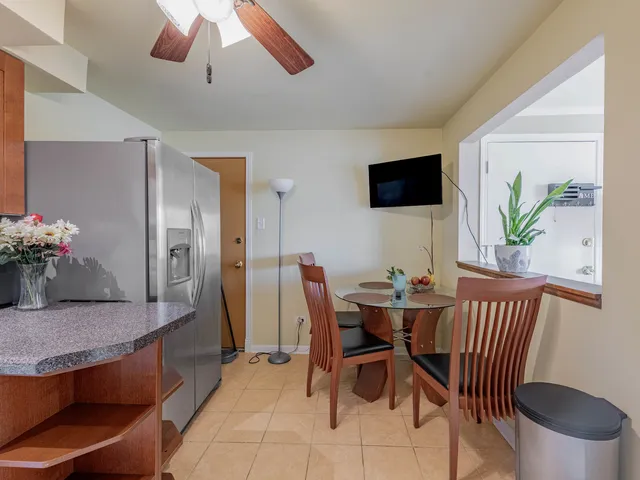 a view of a dining room with furniture and a chandelier