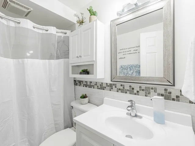 a bathroom with a sink toilet and shower