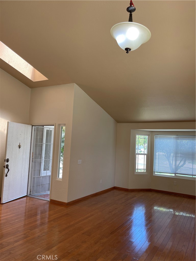 1341 Grovehill Drive Riverside, CA 92507 - Photo 13 of 23 a view of an empty room with wooden floor and a window