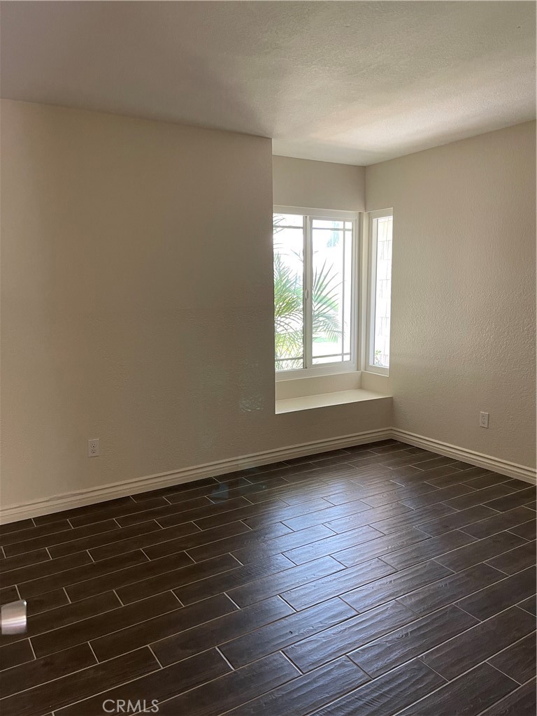 1341 Grovehill Drive Riverside, CA 92507 - Photo 14 of 23 wooden floor in an empty room with a window