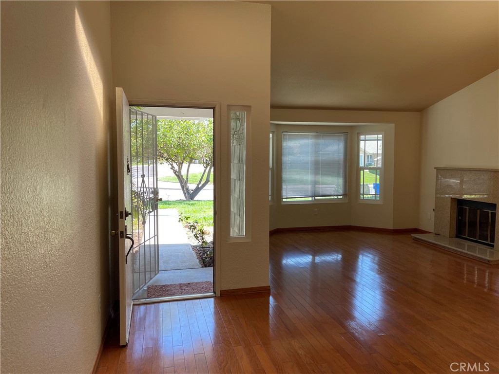 1341 Grovehill Drive Riverside, CA 92507 - Photo 21 of 23 a view of an empty room with wooden floor and a window