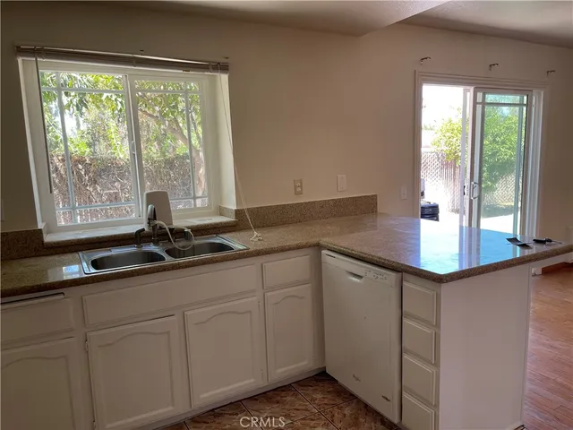 a kitchen with a sink and large window