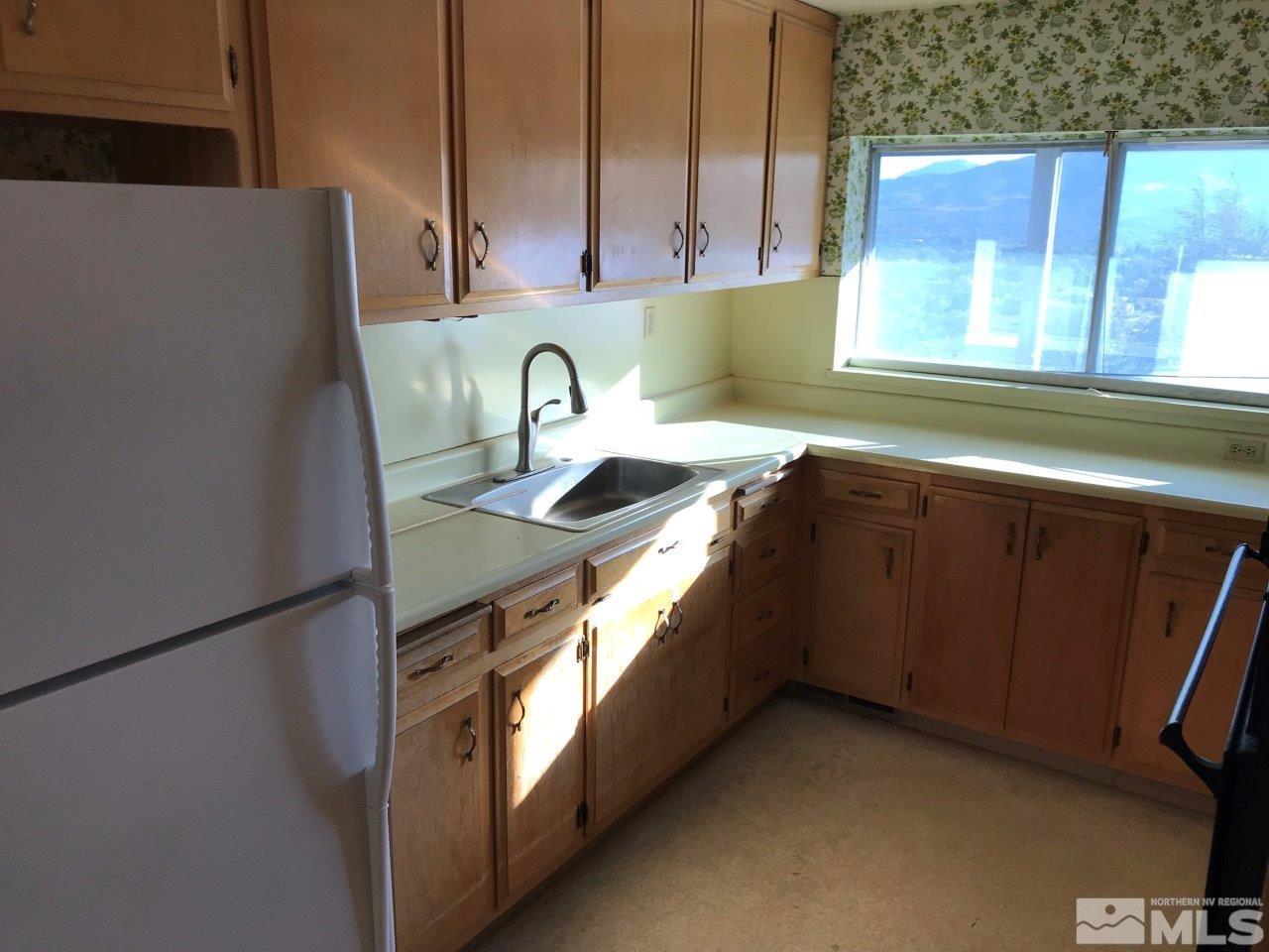 30 Greenstone Circle Reno, NV 89512 - Photo 14 of 34 a kitchen with stainless steel appliances granite countertop a sink a stove and a refrigerator