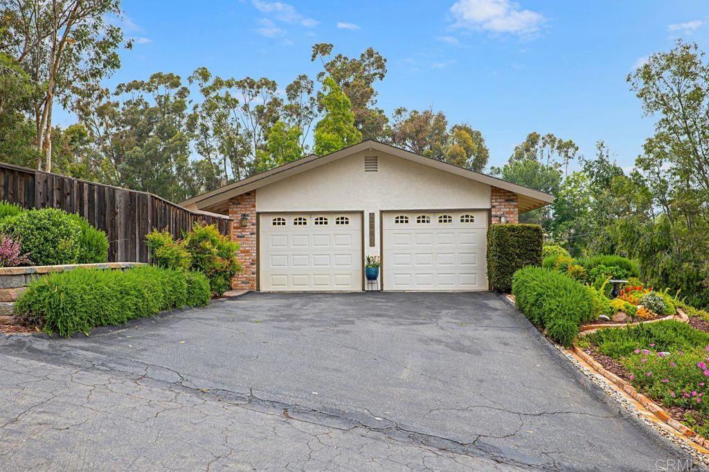 2991 Quail Road Escondido, CA 92026 - Photo 1 of 1 a white house with a small yard plants and a large tree