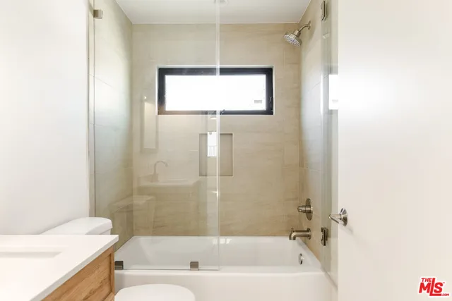 a bathroom with a bathtub and a sink