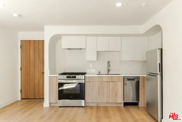 a kitchen with a stove and a refrigerator