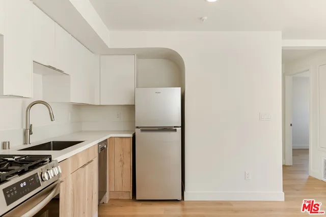 a kitchen with a refrigerator and a stove