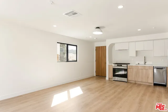 a view of a kitchen with a sink and a stove top oven