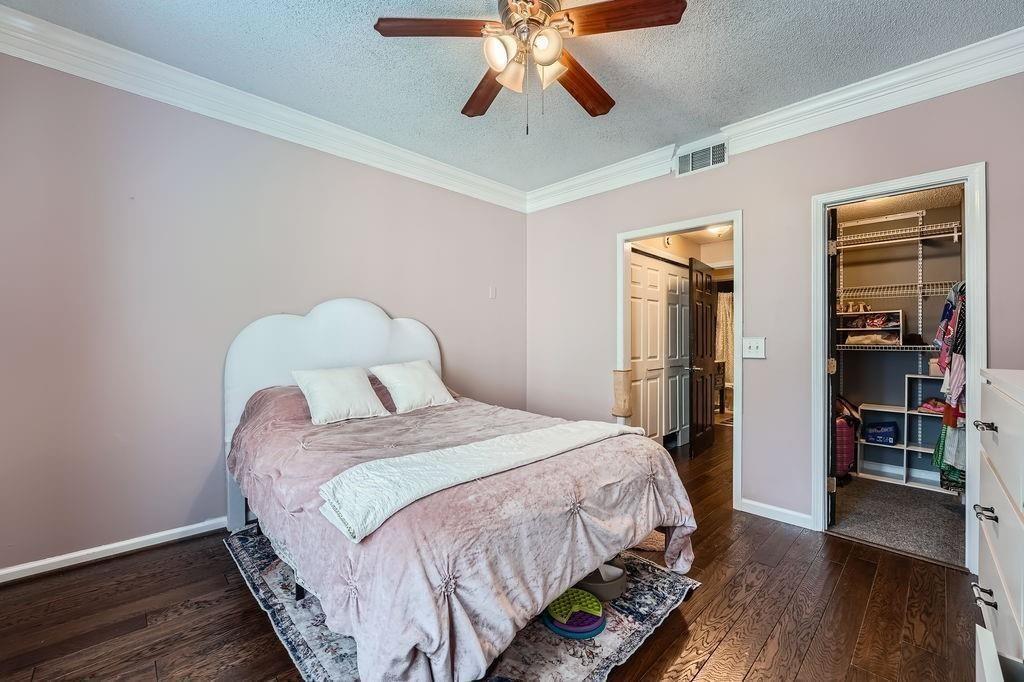 955 Juniper Street Northeast, Unit 4127 Atlanta, GA 30309 - Photo 14 of 29 a bedroom with bed and wooden floor