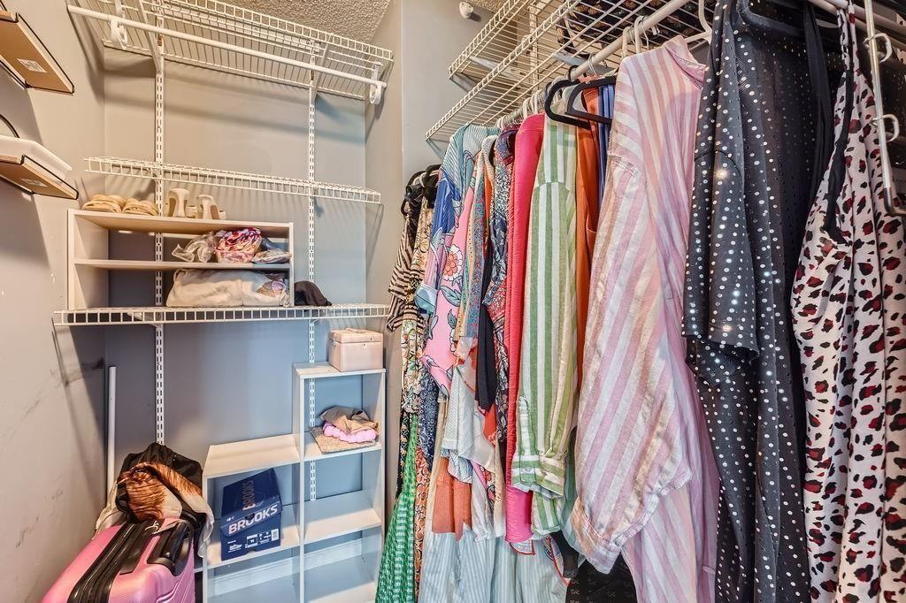 955 Juniper Street Northeast, Unit 4127 Atlanta, GA 30309 - Photo 17 of 29 a view of walk in closet with clothes and shoes
