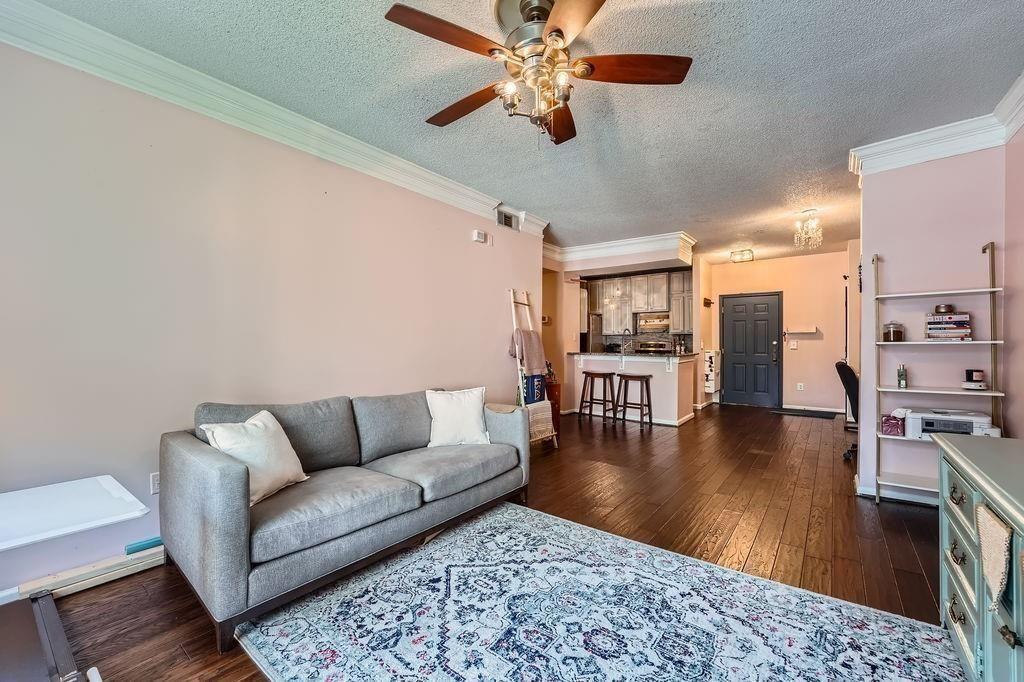955 Juniper Street Northeast, Unit 4127 Atlanta, GA 30309 - Photo 6 of 29 a living room with furniture and a wooden floor