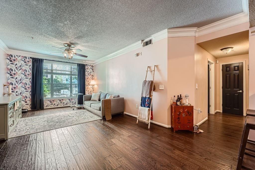 955 Juniper Street Northeast, Unit 4127 Atlanta, GA 30309 - Photo 7 of 29 a living room with furniture and a large window