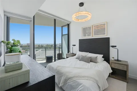 a bedroom with a large bed and a large window