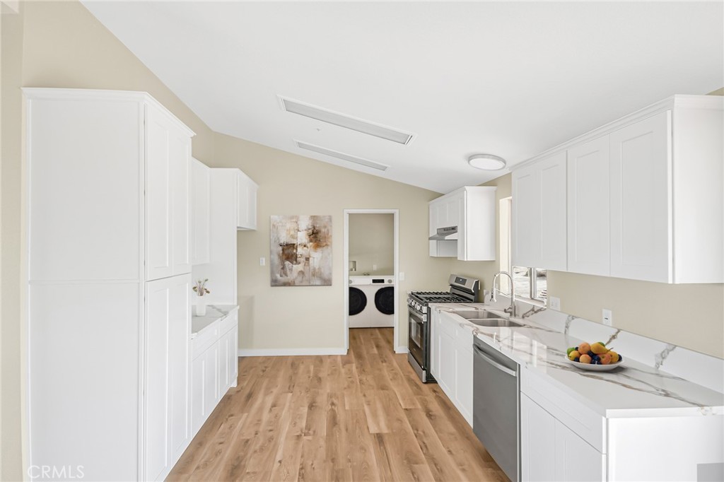 7773 Sequoia Road Phelan, CA 92371 - Photo 6 of 32 a kitchen with a sink a stove a refrigerator and cabinets