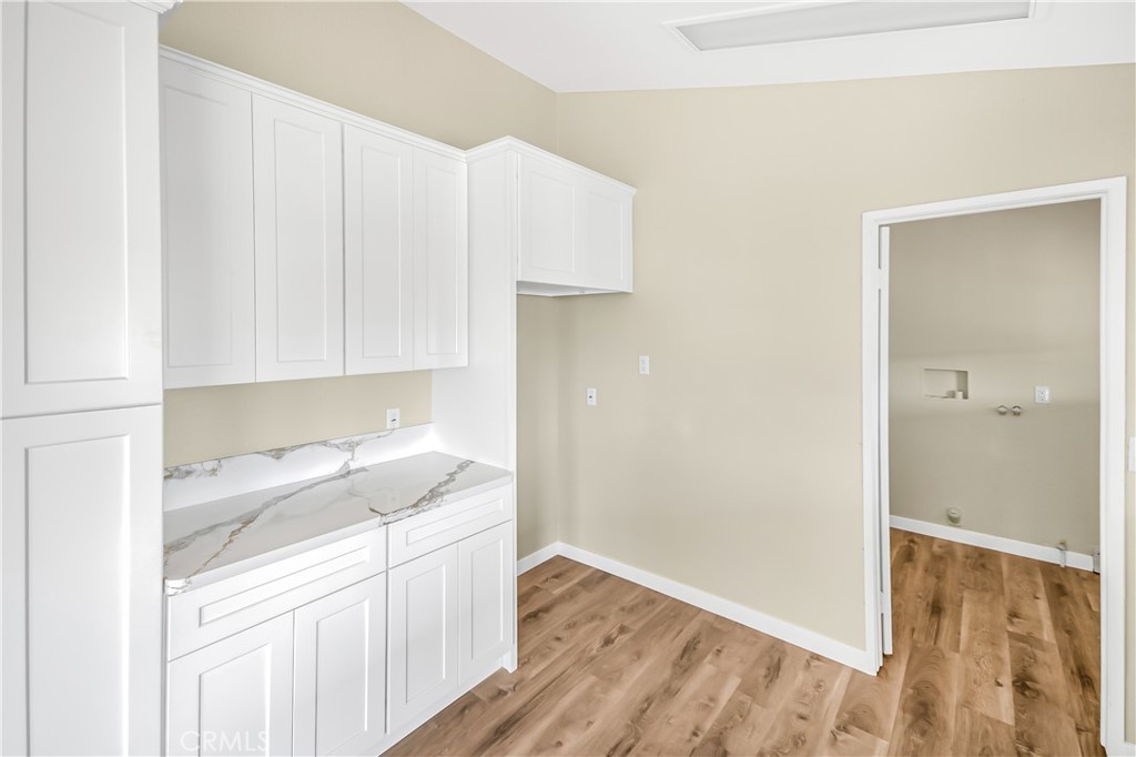 7773 Sequoia Road Phelan, CA 92371 - Photo 7 of 32 a kitchen with a sink cabinets and a stove top oven