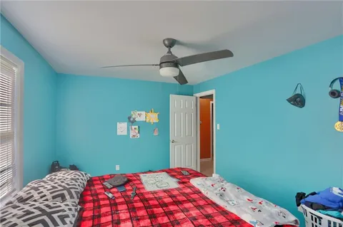 a bedroom with a bed and a window