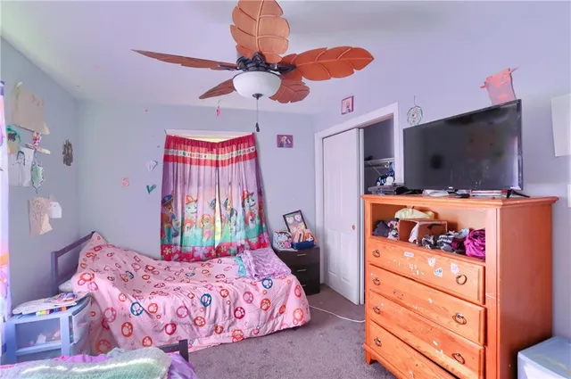 a bedroom with a bed and flat screen tv