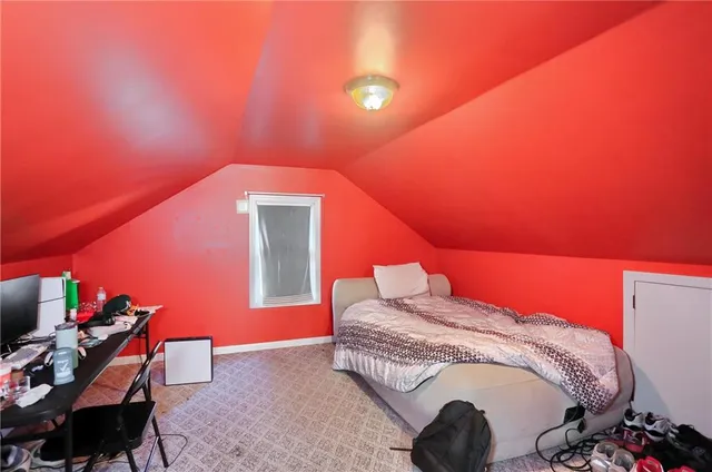 a bedroom with a bed and a potted plant