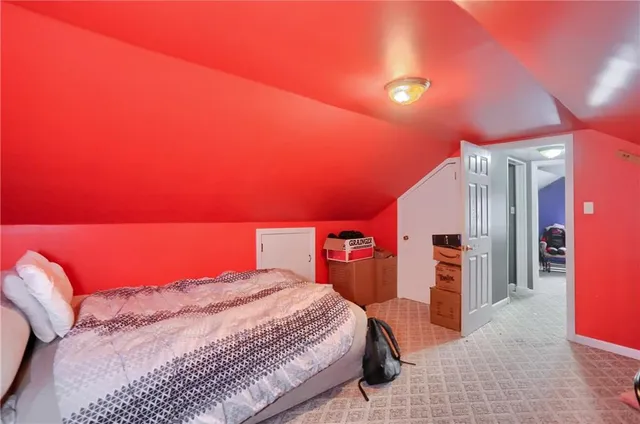 a spacious bedroom with a bed and a lamp