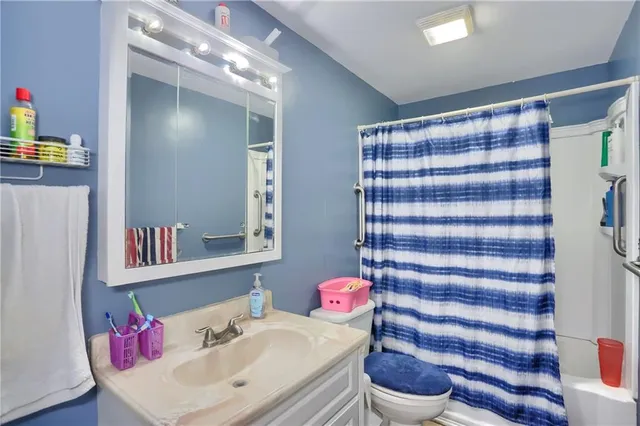 a bathroom with a sink toilet and a mirror