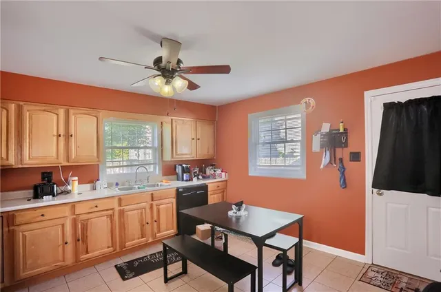 a kitchen with stainless steel appliances a table chairs and a refrigerator