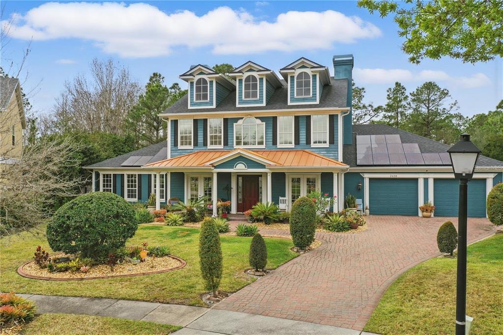 2438 River Rise Court Orlando, FL 32828 - Photo 1 of 1 a front view of a house with a yard and trees