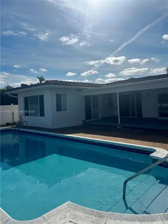 a view of swimming pool with seating space