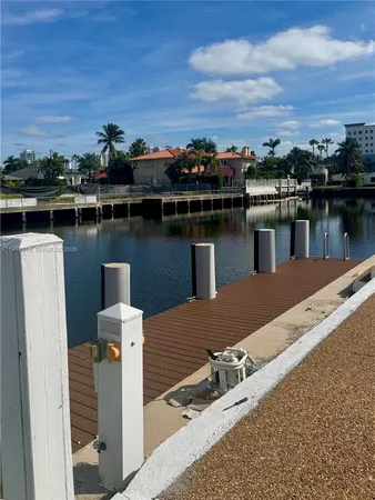 a view of a lake with boats and large trees