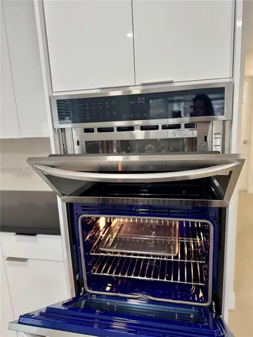 a stove top oven sitting inside of a kitchen