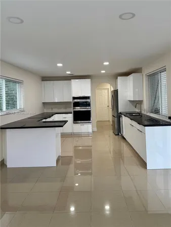 a kitchen with a sink stainless steel appliances and cabinets