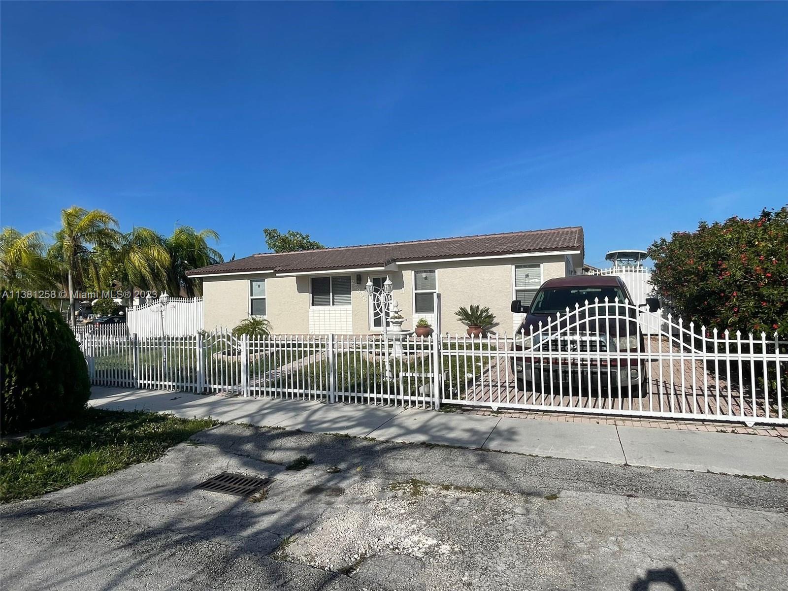 a view of a house with a fence