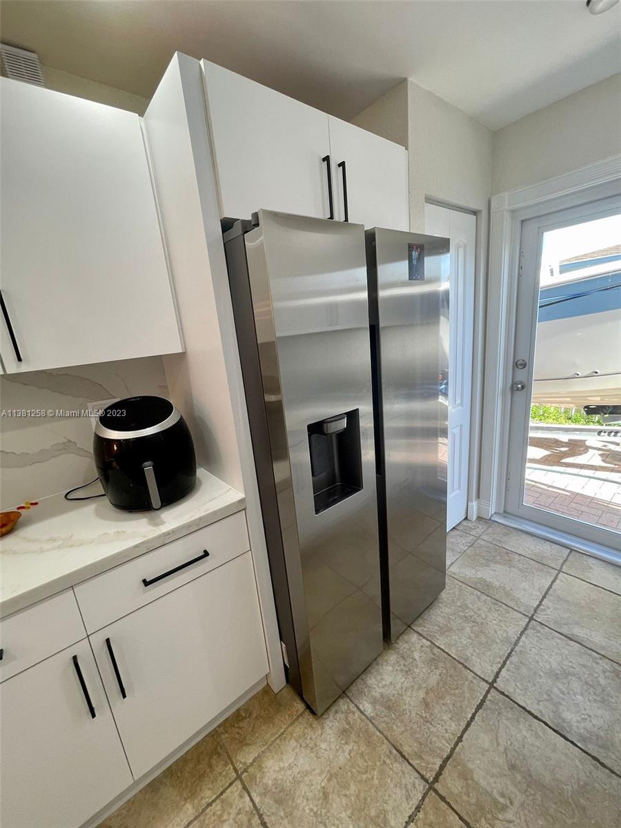 25305 Southwest 124th Court Homestead, FL 33032 - Photo 14 of 39 a kitchen with a refrigerator sink and cabinets