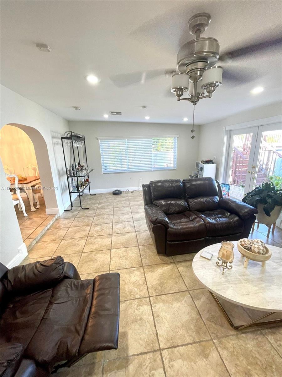25305 Southwest 124th Court Homestead, FL 33032 - Photo 17 of 39 a living room with furniture and a chandelier