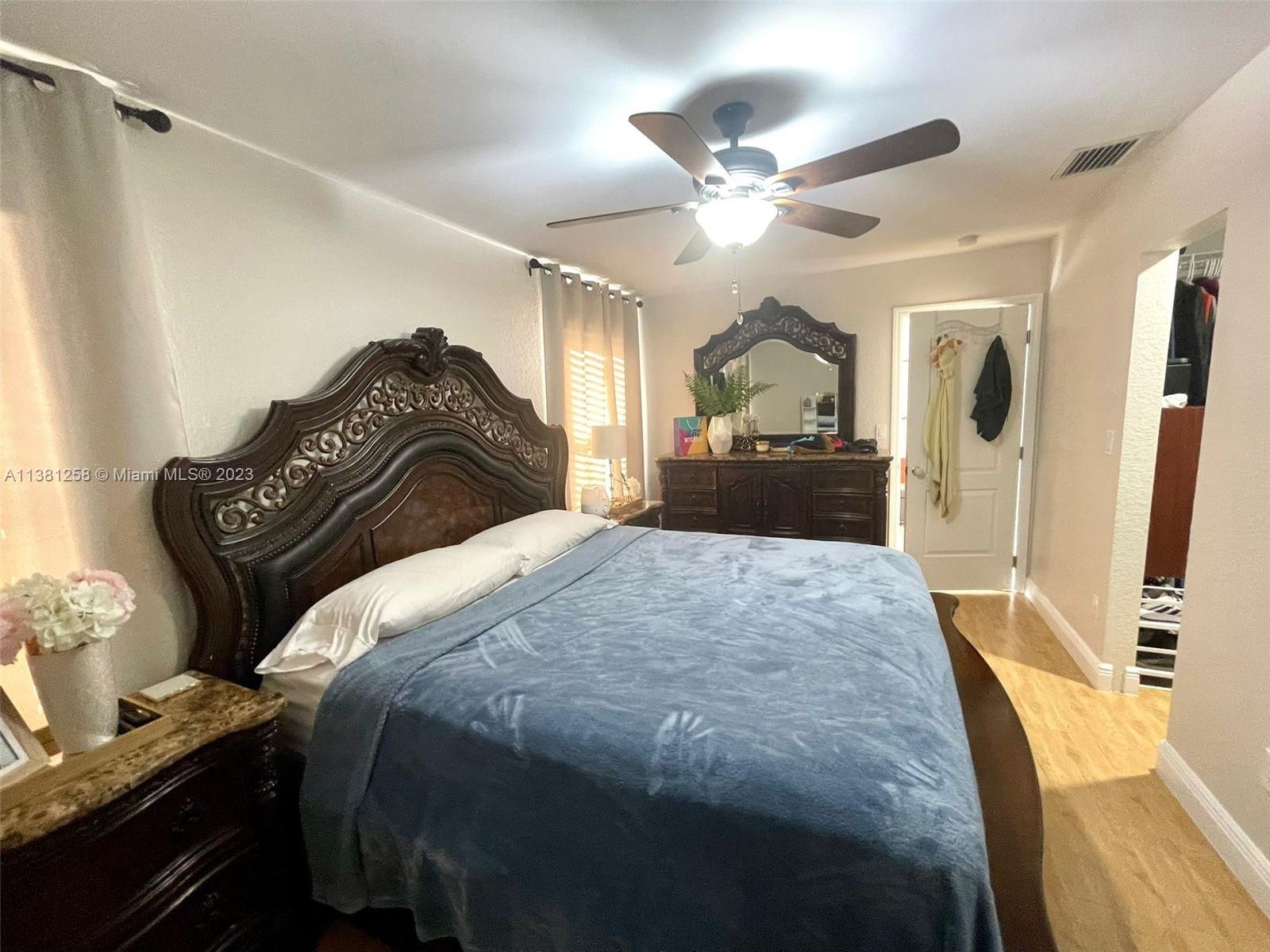 25305 Southwest 124th Court Homestead, FL 33032 - Photo 21 of 39 a bedroom with a bed and wooden floor