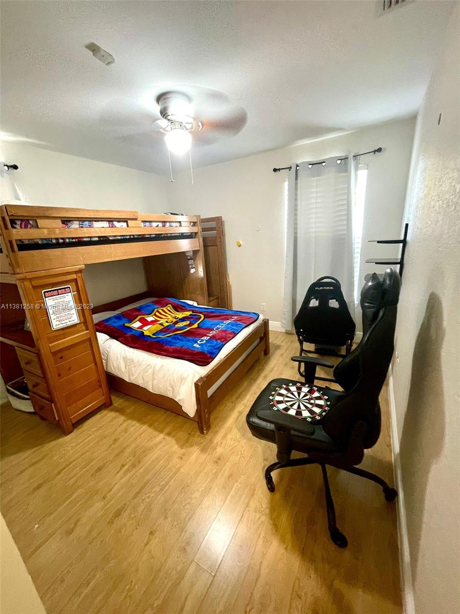 25305 Southwest 124th Court Homestead, FL 33032 - Photo 25 of 39 a room with furniture and gym equipment