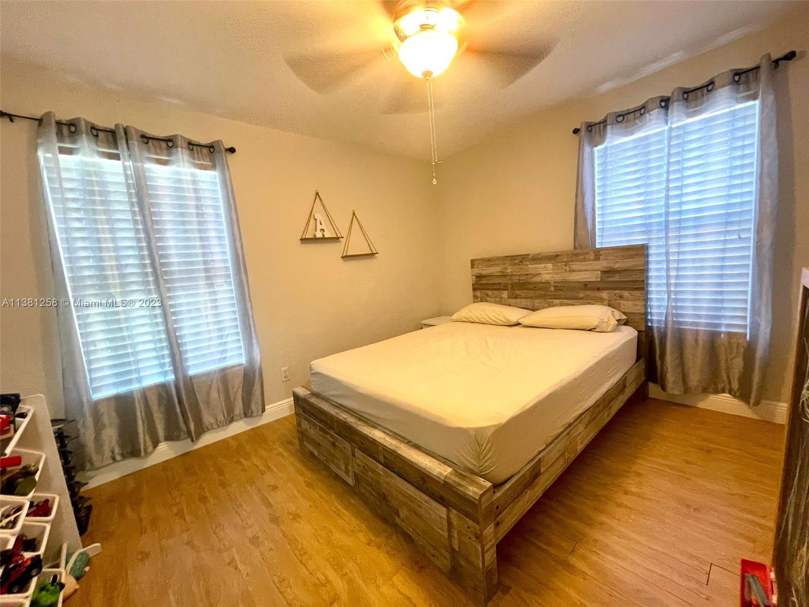 25305 Southwest 124th Court Homestead, FL 33032 - Photo 27 of 39 a bed sitting in a bedroom next to a window