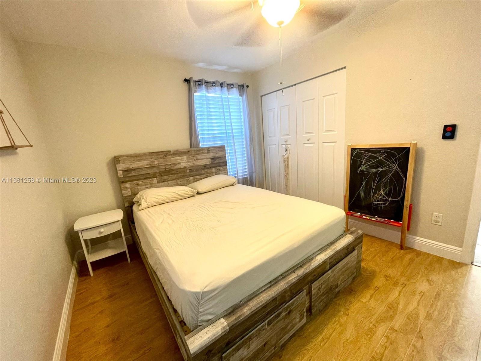 25305 Southwest 124th Court Homestead, FL 33032 - Photo 28 of 39 a bed sitting in a spacious bedroom next to a window