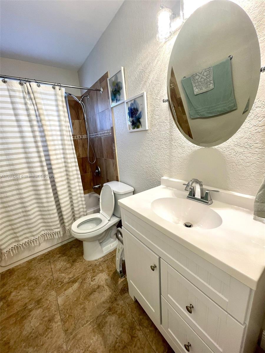 25305 Southwest 124th Court Homestead, FL 33032 - Photo 29 of 39 a bathroom with a sink mirror and toilet