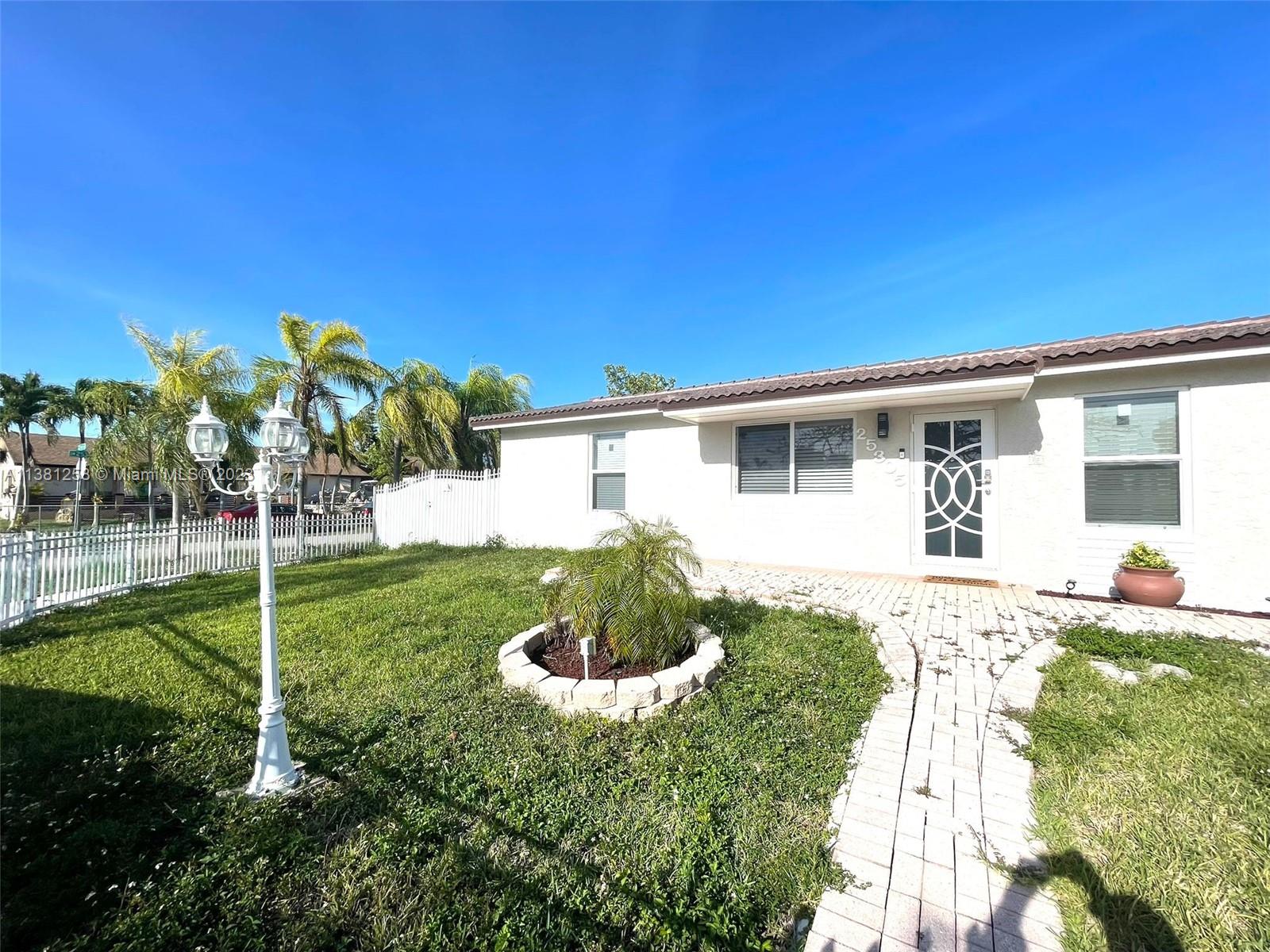 25305 Southwest 124th Court Homestead, FL 33032 - Photo 3 of 39 a house view with a garden space
