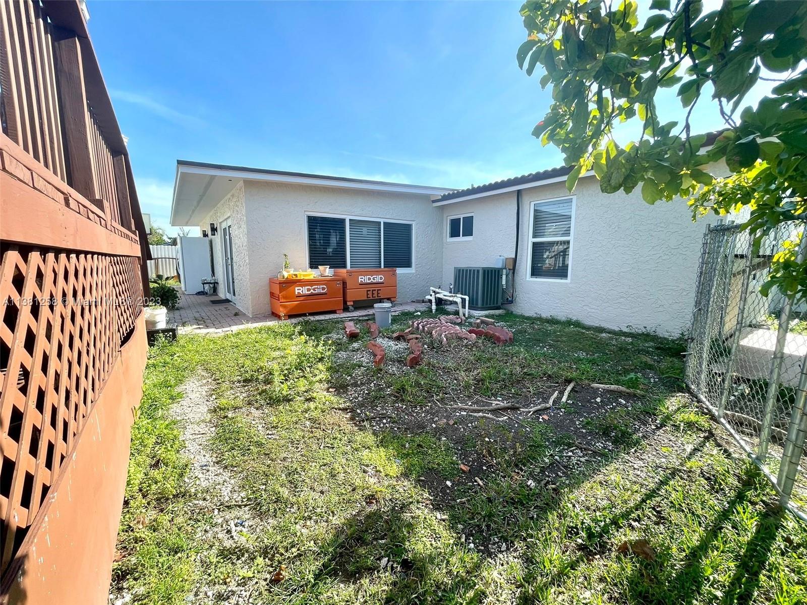 25305 Southwest 124th Court Homestead, FL 33032 - Photo 36 of 39 a backyard of a house with table and chairs