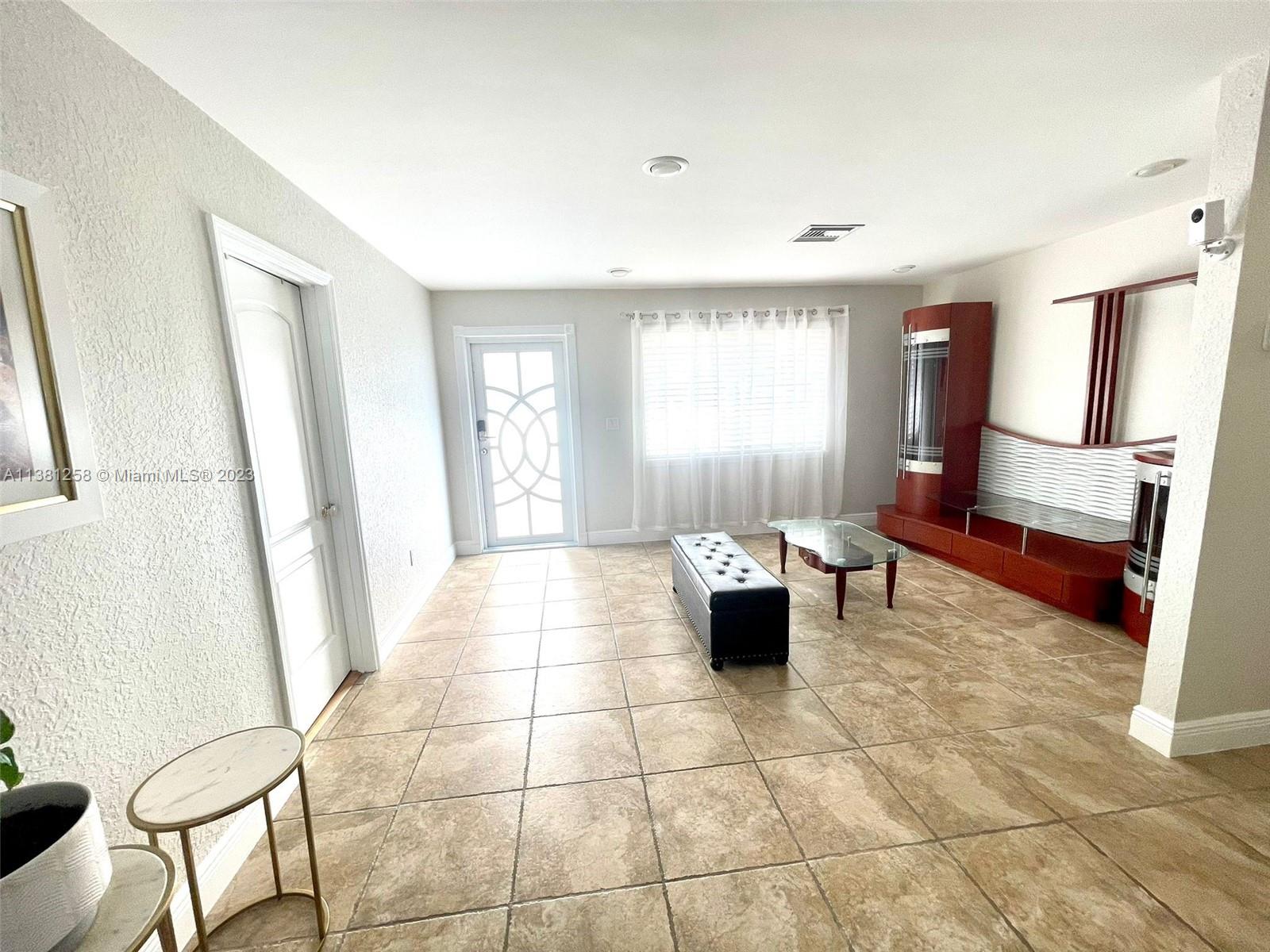 25305 Southwest 124th Court Homestead, FL 33032 - Photo 6 of 39 a living room with furniture and a window