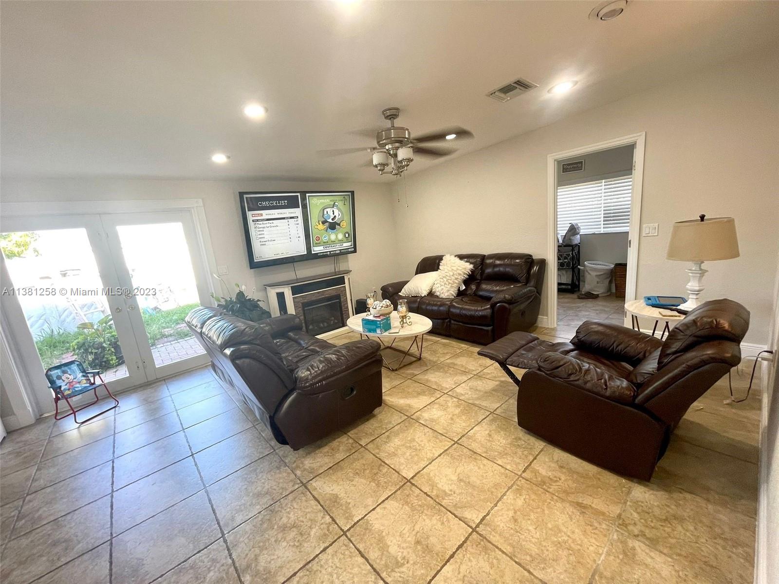 25305 Southwest 124th Court Homestead, FL 33032 - Photo 7 of 39 a living room with furniture and a floor to ceiling window