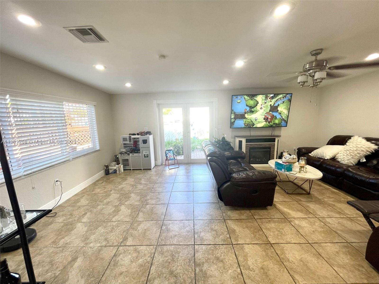 25305 Southwest 124th Court Homestead, FL 33032 - Photo 8 of 39 a living room with furniture and a flat screen tv