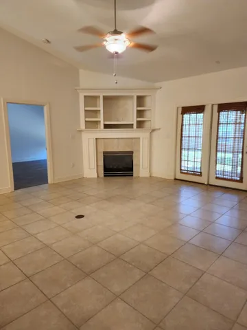 a view of an empty room with a kitchen