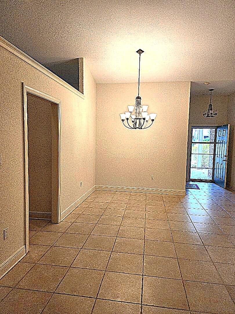 263 Diamond Cove, Unit 263 Destin, FL 32541 - Photo 4 of 11 a view of an empty room with window and wooden floor