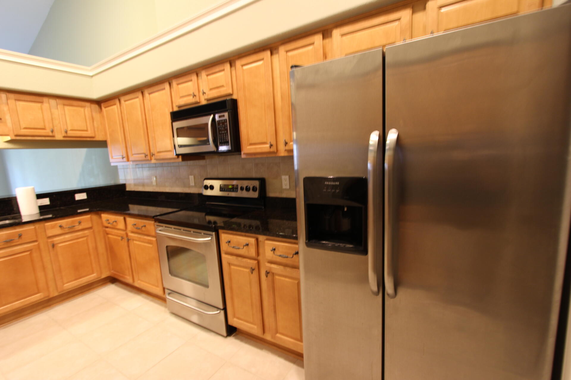 263 Diamond Cove, Unit 263 Destin, FL 32541 - Photo 5 of 11 a kitchen with stainless steel appliances granite countertop a refrigerator a oven a sink with granite countertops and cabinets
