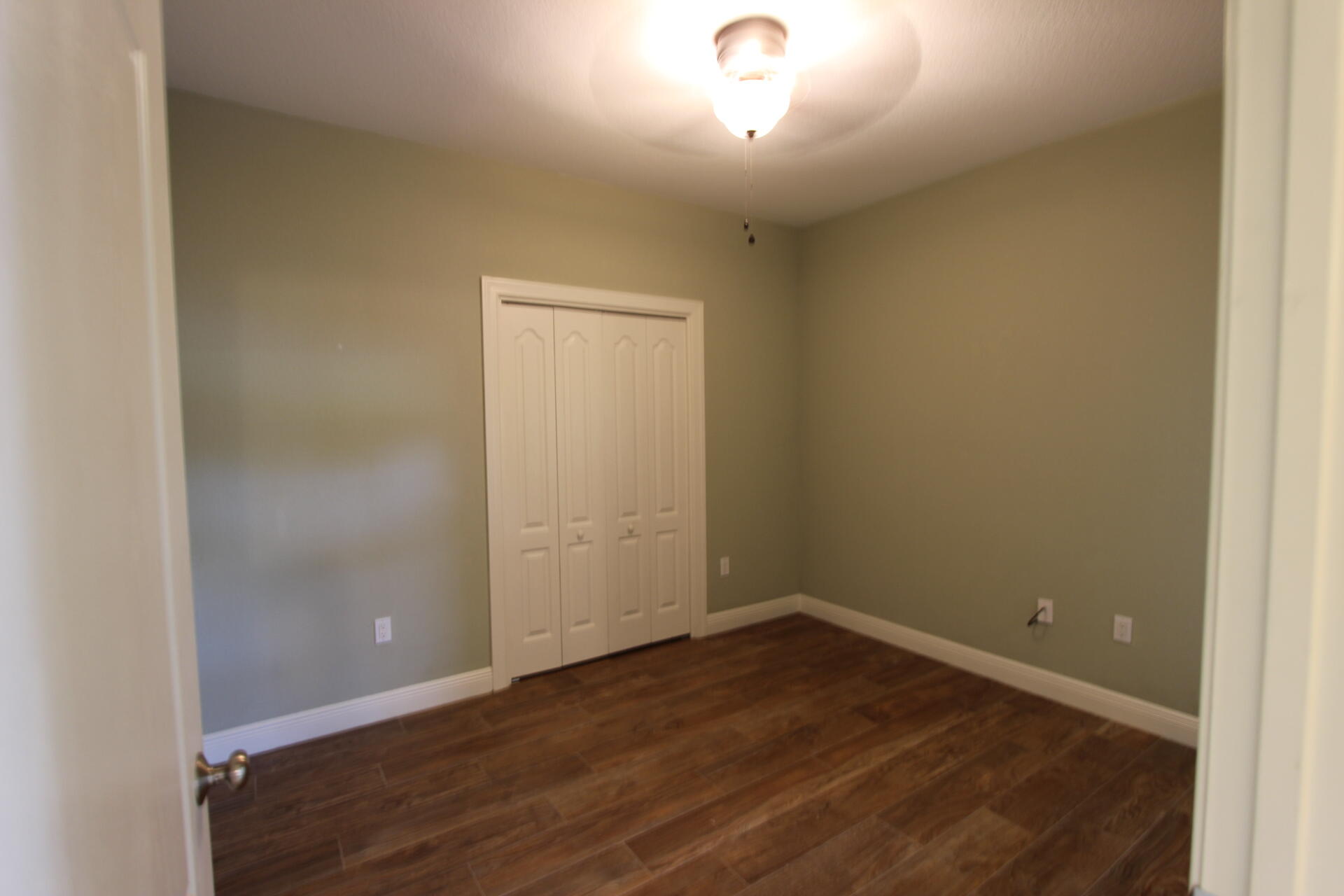 263 Diamond Cove, Unit 263 Destin, FL 32541 - Photo 7 of 11 an empty room with wooden floor and windows
