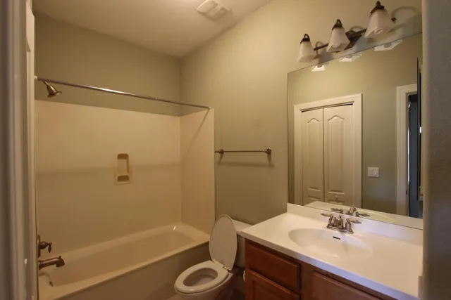 a bathroom with a sink a mirror a bathtub and shower