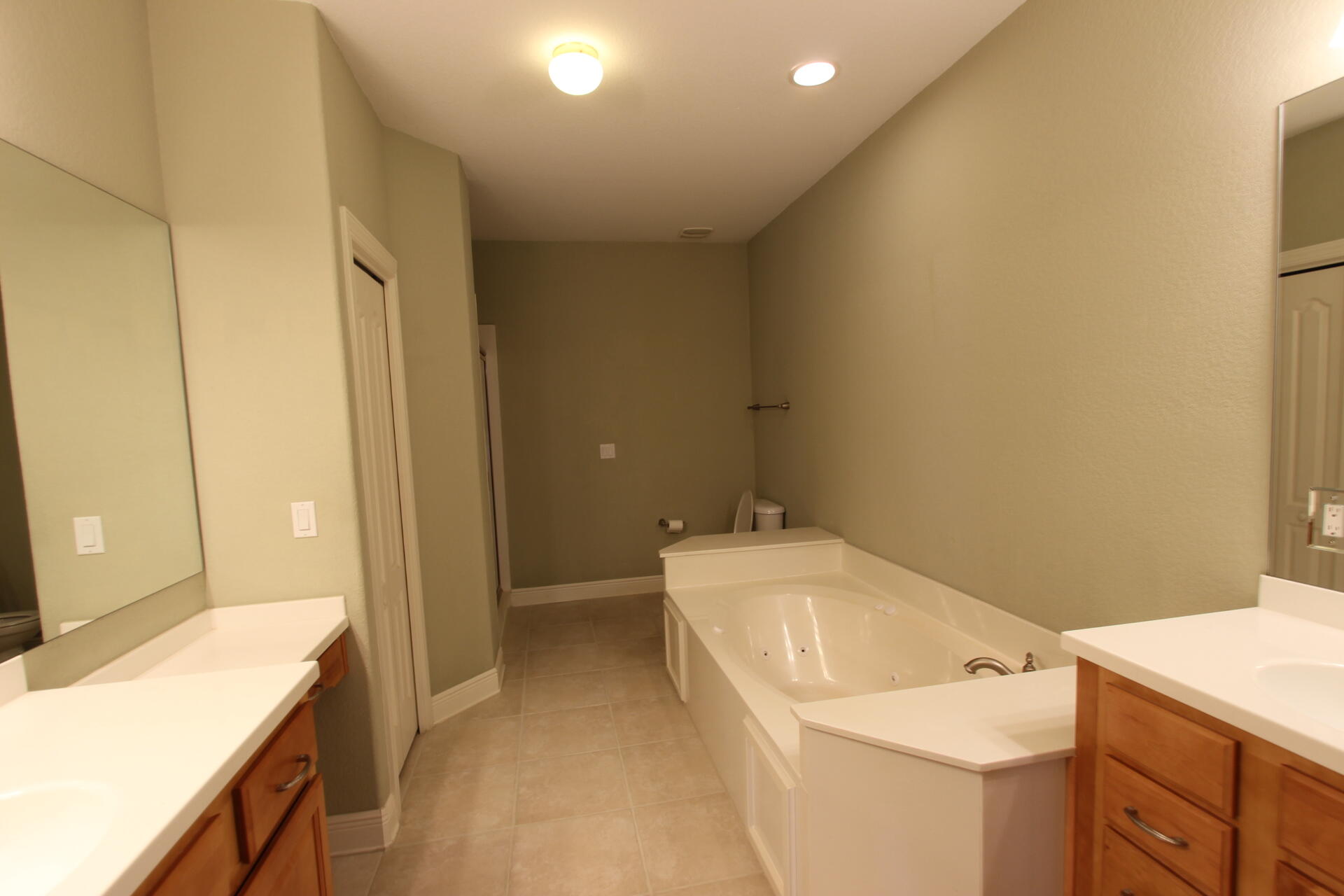 263 Diamond Cove, Unit 263 Destin, FL 32541 - Photo 9 of 11 a bathroom with a sink a toilet and vanity