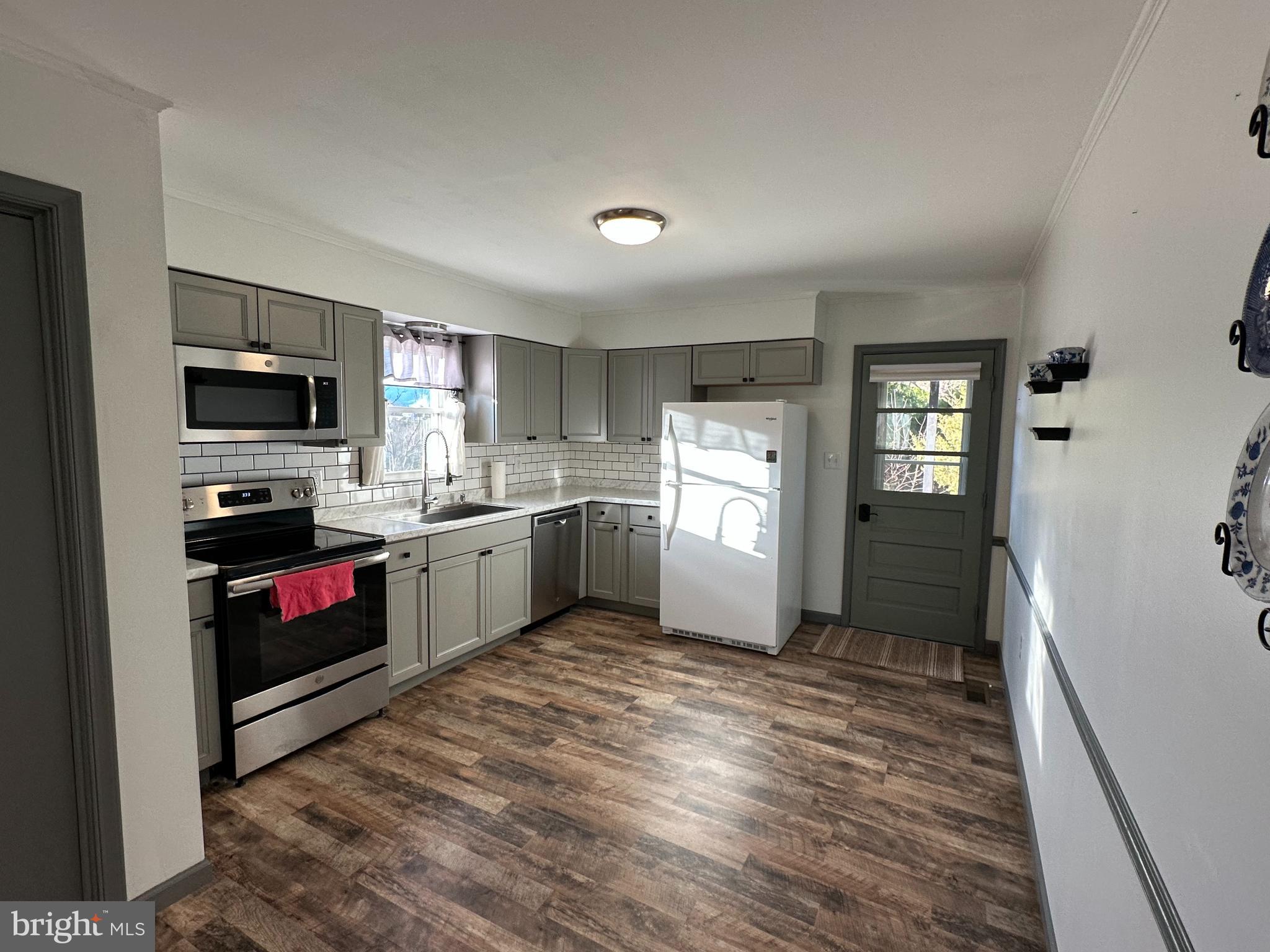 650 Honeyville Road Stanley, VA 22851 - Photo 16 of 27 a kitchen with a refrigerator and a stove top oven